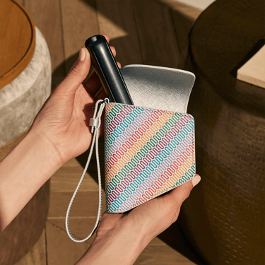 Hand holding a Ploom Duo Carry Case Multicolored Patterned Canvas accessory