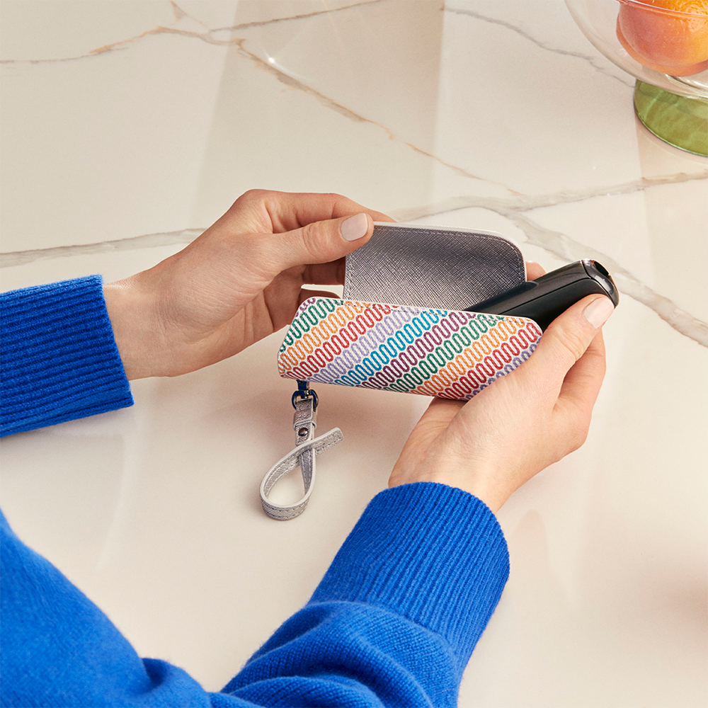 Ploom Aura Multicolored Patterned Canvas Solo Carry Case accessory on a table